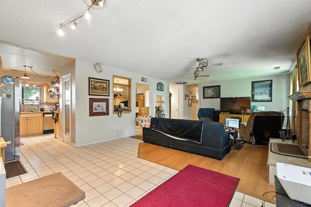 36358 Orange Grove Ave, Madera, CA 93636 - living area with a textured ceiling, ceiling fan, light tile patterned floors, and rail lighting