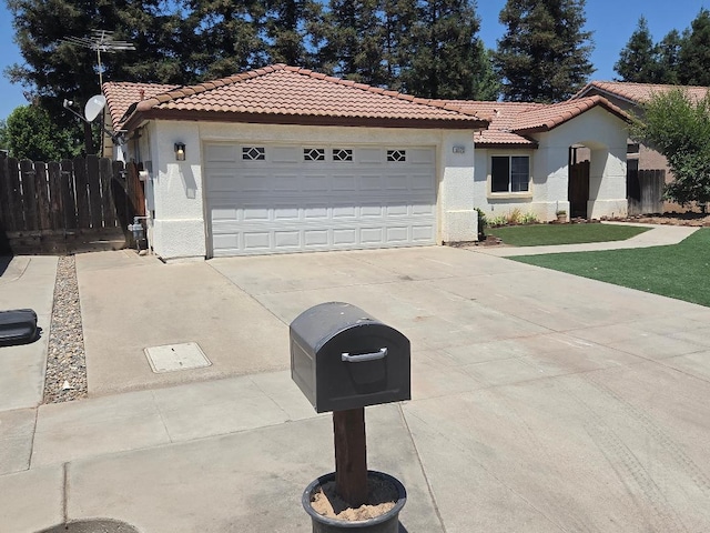 6173 N Marty Ave, Fresno, CA 93711 - view of front of house featuring a tile roof, stucco siding, concrete driveway, and an attached garage