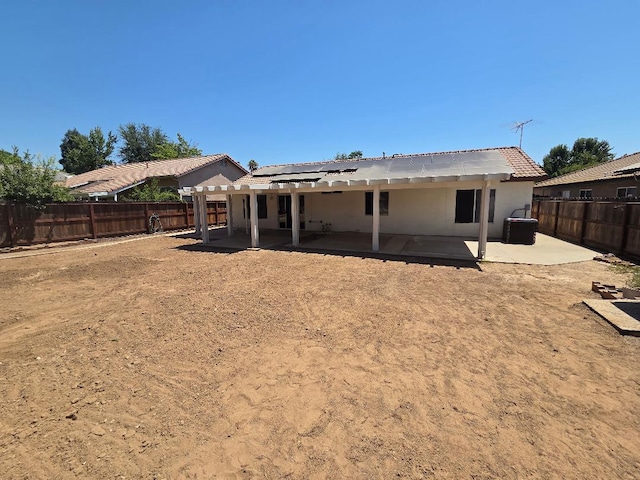 6173 N Marty Ave, Fresno, CA 93711 - rear view of house with a patio area, solar panels, a fenced backyard, and stucco siding