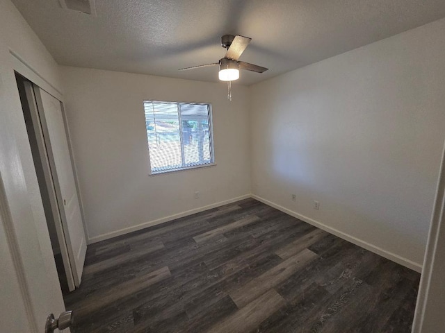 6173 N Marty Ave, Fresno, CA 93711 - unfurnished bedroom with dark wood-type flooring, a closet, a textured ceiling, and a ceiling fan
