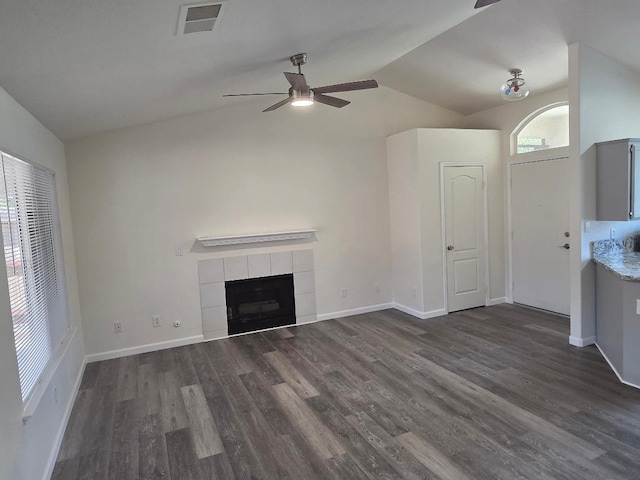 6173 N Marty Ave, Fresno, CA 93711 - unfurnished living room featuring a ceiling fan, lofted ceiling, wood finished floors, and a tiled fireplace