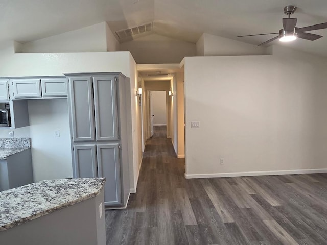 6173 N Marty Ave, Fresno, CA 93711 - kitchen with vaulted ceiling, a ceiling fan, dark wood-type flooring, light stone counters, and gray cabinets