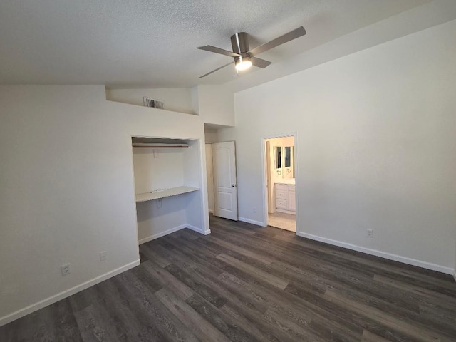 6173 N Marty Ave, Fresno, CA 93711 - unfurnished bedroom featuring vaulted ceiling, dark wood finished floors, a textured ceiling, ensuite bath, and built in desk