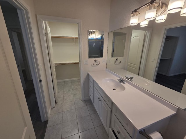 6173 N Marty Ave, Fresno, CA 93711 - bathroom featuring vanity, tile patterned floors, and a walk in closet