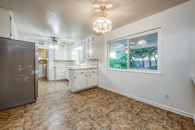 7343 N 4th St, Fresno, CA 93720 - kitchen featuring freestanding refrigerator, a chandelier, white cabinetry, a ceiling fan, and a peninsula