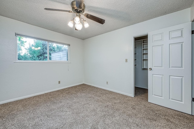 7343 N 4th St, Fresno, CA 93720 - unfurnished bedroom featuring a spacious closet, carpet flooring, a textured ceiling, and ceiling fan