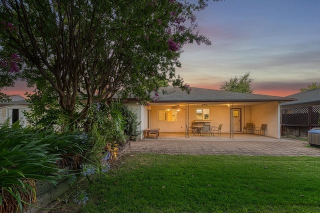 7343 N 4th St, Fresno, CA 93720 - back of property featuring stucco siding, a patio, and a lawn