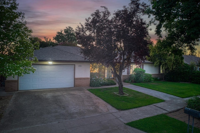 7343 N 4th St, Fresno, CA 93720 - view of property hidden behind natural elements featuring brick siding, concrete driveway, a front yard, an attached garage, and roof with shingles
