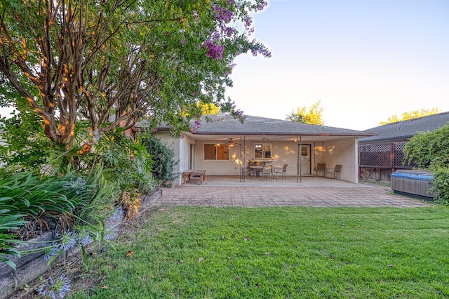 7343 N 4th St, Fresno, CA 93720 - rear view of house with a patio area, a hot tub, stucco siding, and ceiling fan