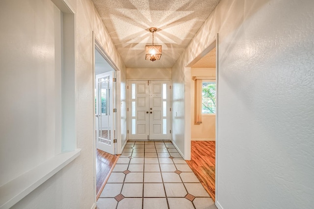 7343 N 4th St, Fresno, CA 93720 - entrance foyer with a chandelier, a textured wall, and light wood-type flooring