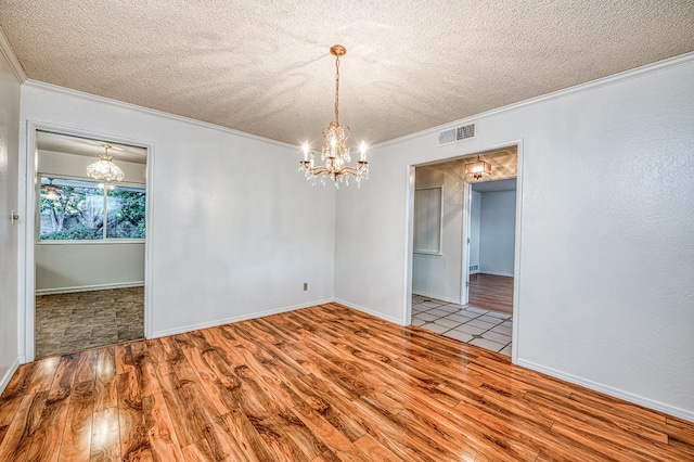7343 N 4th St, Fresno, CA 93720 - empty room featuring a chandelier, crown molding, a textured ceiling, and wood finished floors