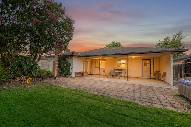 7343 N 4th St, Fresno, CA 93720 - back of property at dusk featuring stucco siding and a patio