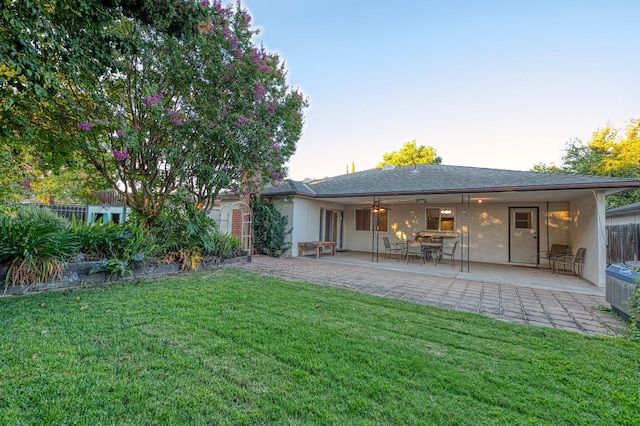 7343 N 4th St, Fresno, CA 93720 - rear view of house featuring a lawn, a patio area, and stucco siding