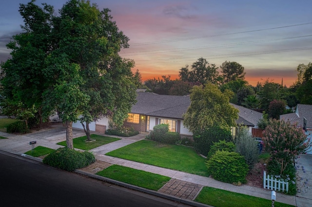 7343 N 4th St, Fresno, CA 93720 - view of front facade with a front yard, roof with shingles, brick siding, an attached garage, and driveway