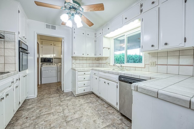 7343 N 4th St, Fresno, CA 93720 - kitchen with black appliances, washing machine and clothes dryer, ceiling fan, white cabinetry, and backsplash