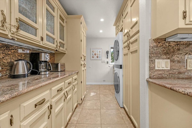 36522 Mudge Ranch Rd, Coarsegold, CA 93614 - laundry room with stacked washer and clothes dryer, light tile patterned floors, and recessed lighting