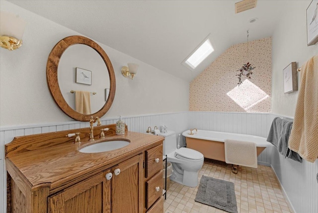 36522 Mudge Ranch Rd, Coarsegold, CA 93614 - bathroom featuring lofted ceiling, a wainscoted wall, vanity, a freestanding tub, and tile patterned floors