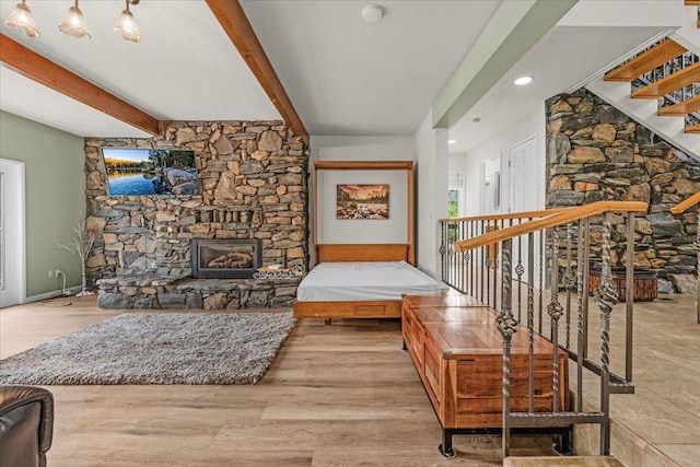 36522 Mudge Ranch Rd, Coarsegold, CA 93614 - living area with beamed ceiling, a stone fireplace, wood finished floors, recessed lighting, and stairs