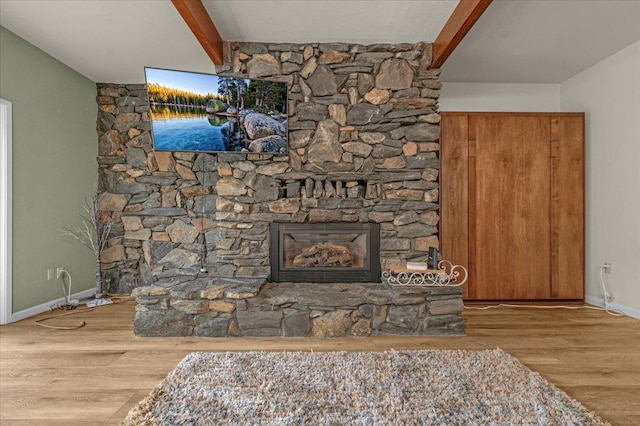 36522 Mudge Ranch Rd, Coarsegold, CA 93614 - living room featuring a fireplace, wood finished floors, and beamed ceiling