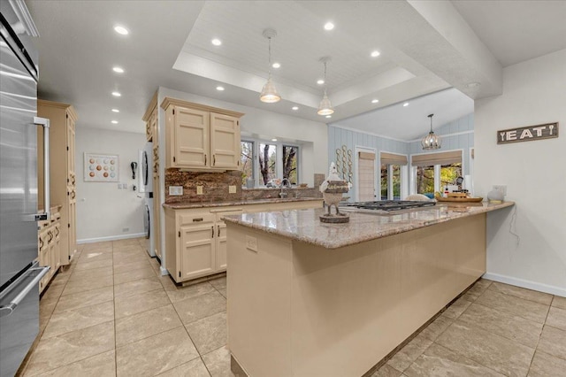 36522 Mudge Ranch Rd, Coarsegold, CA 93614 - kitchen with a tray ceiling, a peninsula, healthy amount of natural light, light stone countertops, and recessed lighting
