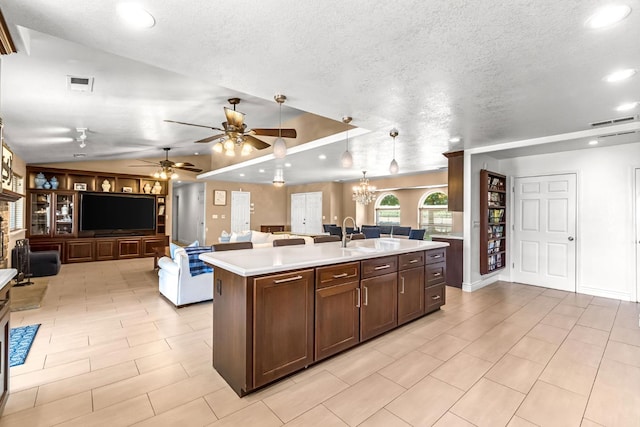 6421 S Greenwood Ave, Del Rey, CA 93616 - kitchen with open floor plan, vaulted ceiling, light countertops, a center island with sink, and ceiling fan