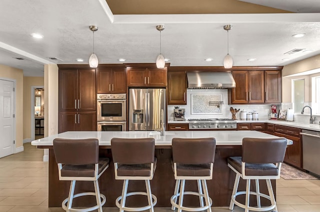 6421 S Greenwood Ave, Del Rey, CA 93616 - kitchen featuring appliances with stainless steel finishes, wall chimney exhaust hood, light countertops, backsplash, and recessed lighting