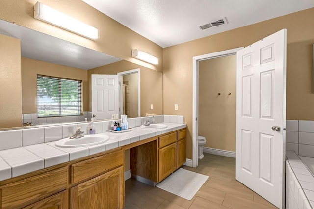 6421 S Greenwood Ave, Del Rey, CA 93616 - full bathroom with double vanity, tile patterned flooring, and a tub