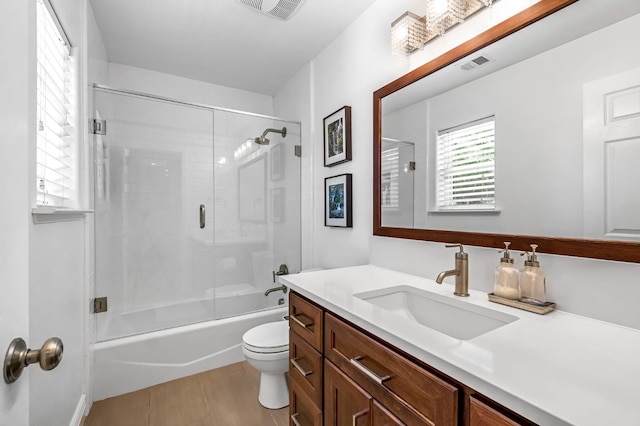 6421 S Greenwood Ave, Del Rey, CA 93616 - bathroom featuring vanity, combined bath / shower with glass door, and wood finished floors