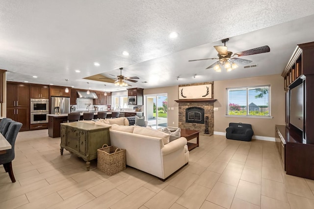 6421 S Greenwood Ave, Del Rey, CA 93616 - living room with a ceiling fan, a fireplace, recessed lighting, a textured ceiling, and a raised ceiling