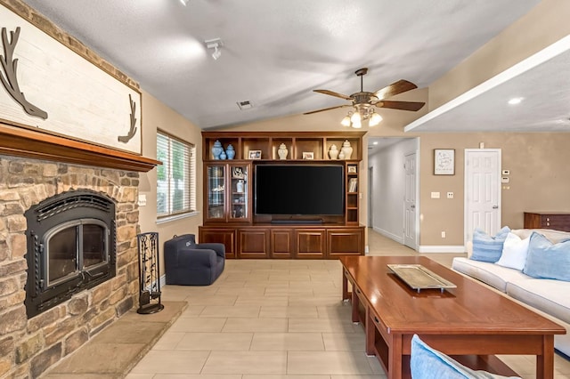 6421 S Greenwood Ave, Del Rey, CA 93616 - living room with a stone fireplace, a ceiling fan, lofted ceiling, and light tile patterned flooring