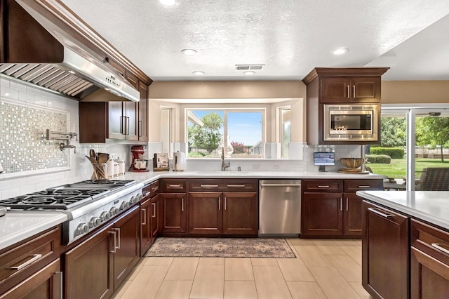 6421 S Greenwood Ave, Del Rey, CA 93616 - kitchen with appliances with stainless steel finishes, under cabinet range hood, light countertops, tasteful backsplash, and healthy amount of natural light
