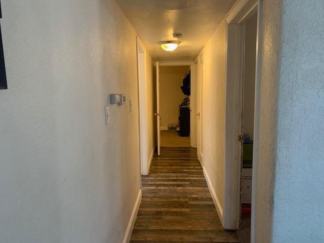 3614 E Washington Ave, Fresno, CA 93702 - corridor featuring dark wood-type flooring and a textured wall