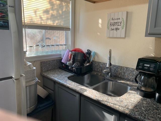 3614 E Washington Ave, Fresno, CA 93702 - kitchen with freestanding refrigerator and gray cabinetry