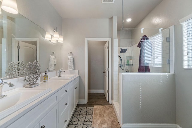 6236 E Garland Ave, Fresno, CA 93727 - full bath with double vanity, a walk in shower, healthy amount of natural light, and tile patterned floors