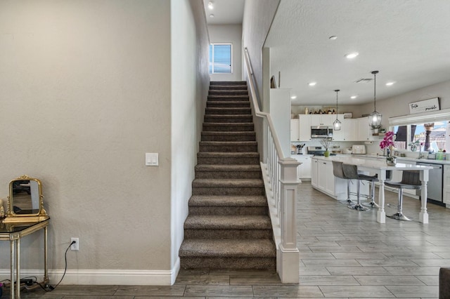 6236 E Garland Ave, Fresno, CA 93727 - staircase with wood finish floors and recessed lighting