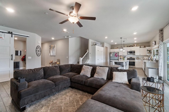 6236 E Garland Ave, Fresno, CA 93727 - living room with a barn door, a ceiling fan, recessed lighting, and stairs