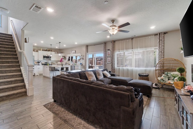 6236 E Garland Ave, Fresno, CA 93727 - living area with a textured ceiling, stairs, ceiling fan, light wood-type flooring, and recessed lighting