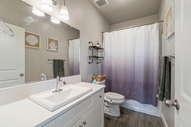 6236 E Garland Ave, Fresno, CA 93727 - full bath featuring wood finished floors, vanity, and a shower with curtain