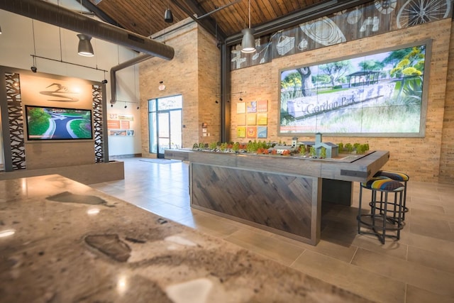 4090 Brent Rd, Madera, CA 93636 - bar featuring a towering ceiling, brick wall, and tile patterned flooring
