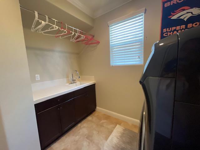 2291 E Prestwick Ave, Fresno, CA 93730 - laundry area with ornamental molding and cabinet space