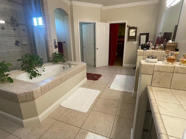 2291 E Prestwick Ave, Fresno, CA 93730 - full bathroom featuring crown molding, a bath, tile patterned flooring, and a tile shower
