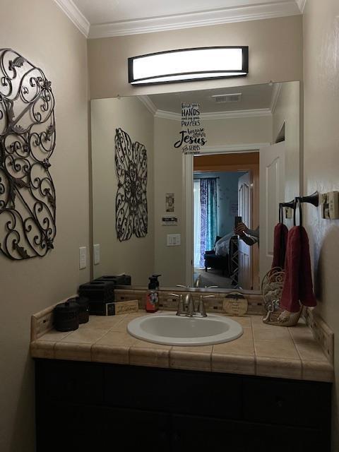 2291 E Prestwick Ave, Fresno, CA 93730 - bathroom featuring vanity, plenty of natural light, and crown molding