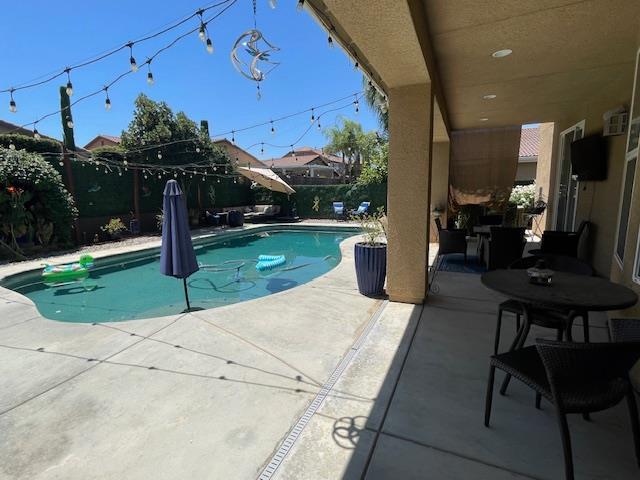 2291 E Prestwick Ave, Fresno, CA 93730 - view of swimming pool featuring a fenced backyard and a patio