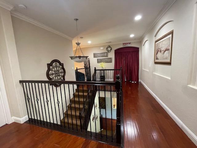 2291 E Prestwick Ave, Fresno, CA 93730 - hallway featuring wood finished floors, ornamental molding, recessed lighting, and an upstairs landing