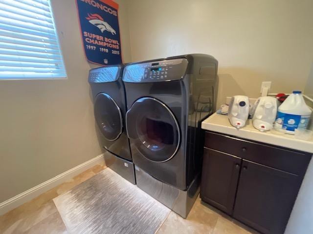 2291 E Prestwick Ave, Fresno, CA 93730 - laundry area featuring washer and dryer, cabinet space, and light tile patterned floors