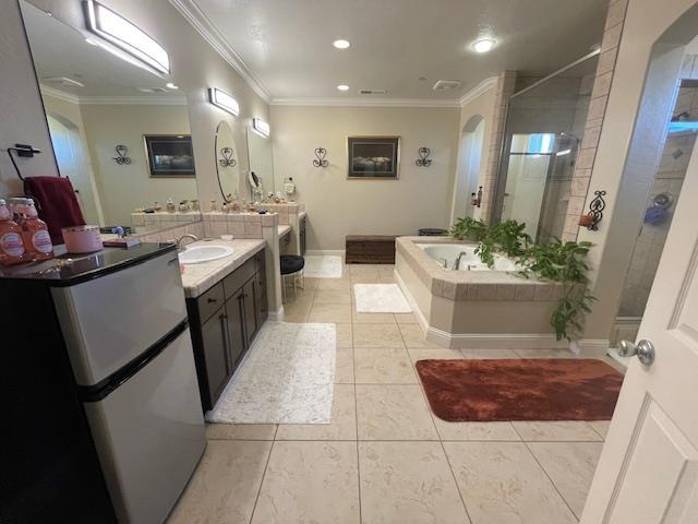 2291 E Prestwick Ave, Fresno, CA 93730 - bathroom with tile patterned flooring, a garden tub, vanity, a shower stall, and ornamental molding