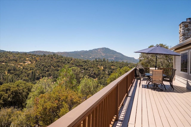 39397 Moonray Ln, Oakhurst, CA 93644 - wooden deck with a mountain view, outdoor dining space, and a view of trees
