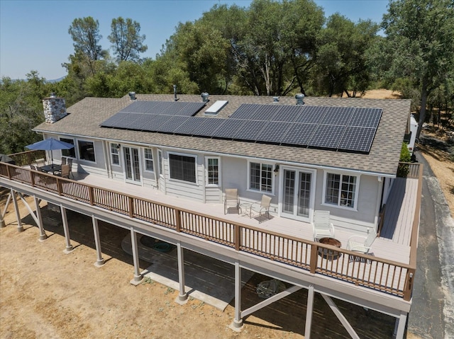 39397 Moonray Ln, Oakhurst, CA 93644 - back of property featuring a shingled roof, french doors, a deck, a chimney, and solar panels