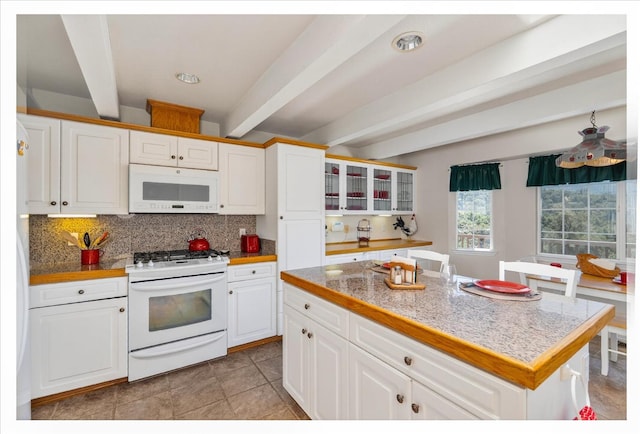 39397 Moonray Ln, Oakhurst, CA 93644 - kitchen with white appliances, beamed ceiling, glass insert cabinets, white cabinetry, and tasteful backsplash