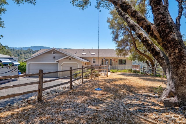 39397 Moonray Ln, Oakhurst, CA 93644 - ranch-style house with an attached garage, covered porch, and driveway